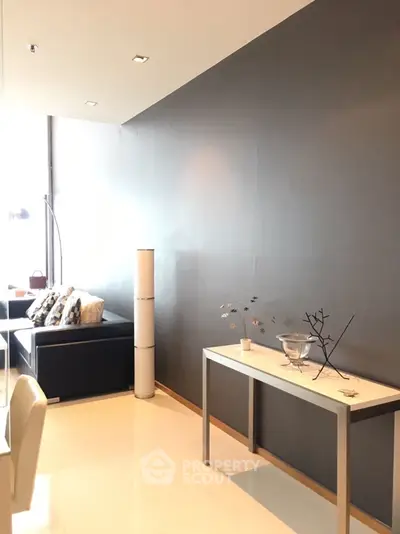 Modern living room with sleek black sofa and minimalist decor