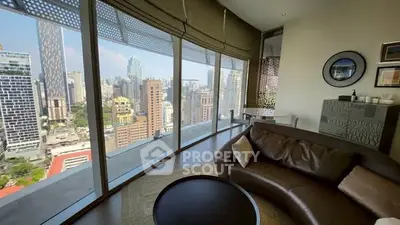 Luxurious high-rise living room with stunning city skyline view and modern decor.