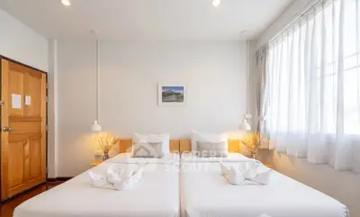 Bright and cozy bedroom with twin beds and elegant decor