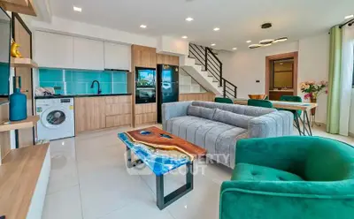 Modern open-plan living room with stylish furniture and vibrant decor in a contemporary home.