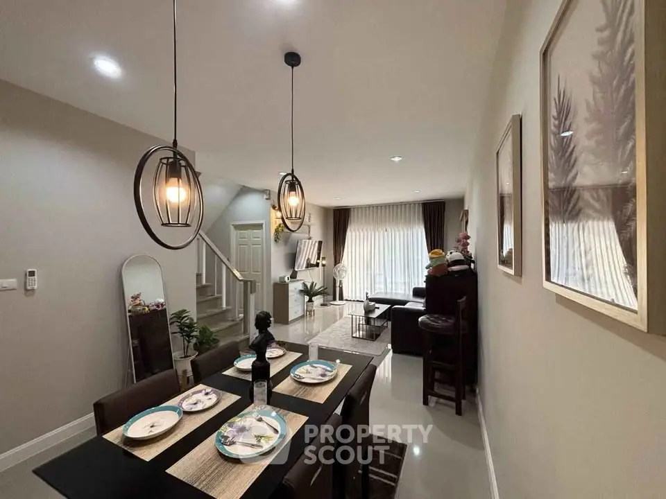 Modern dining and living area with stylish lighting and decor, perfect for entertaining.