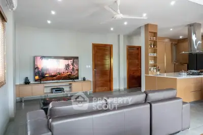 Modern living room with sleek furniture and open kitchen layout