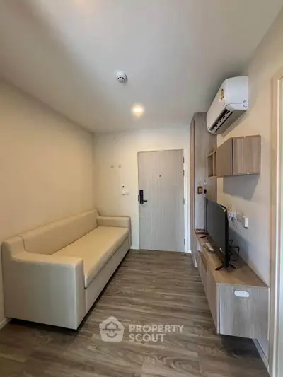 Modern living room with sleek furniture and air conditioning in a cozy apartment.