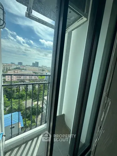 Stunning high-rise balcony view with cityscape and lush greenery.