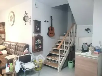 Charming living room with staircase and cozy decor in a modern home