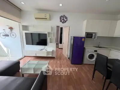 Modern living room with sleek furniture and appliances, featuring a wall-mounted TV and stylish decor.