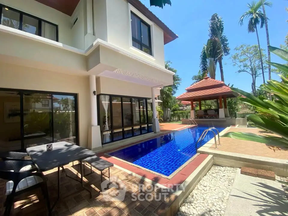 Luxurious villa with private pool and outdoor dining area in tropical setting