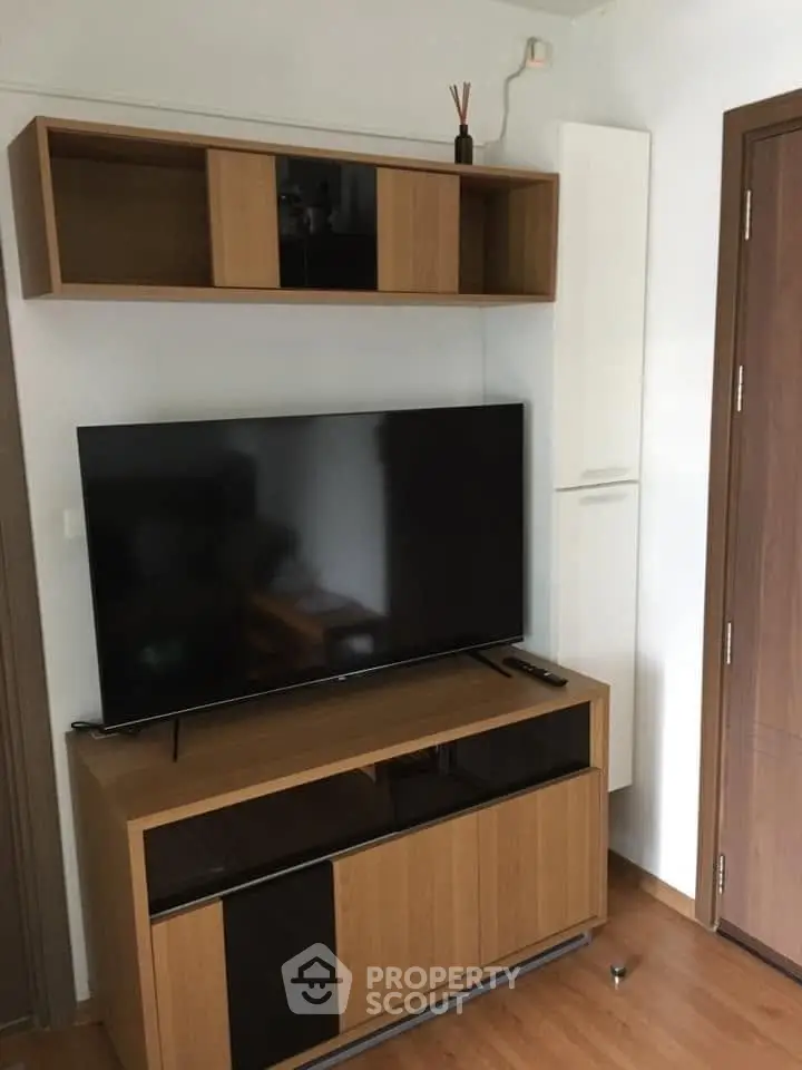 Modern living room with sleek TV stand and wall-mounted shelves