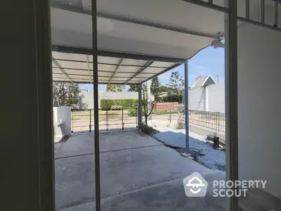 Spacious covered patio with garden view in modern home