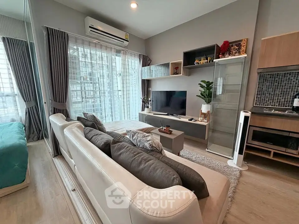 Modern living room with stylish decor and large windows in a contemporary apartment.