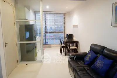 Modern living room with sleek furniture and large windows in a stylish apartment.