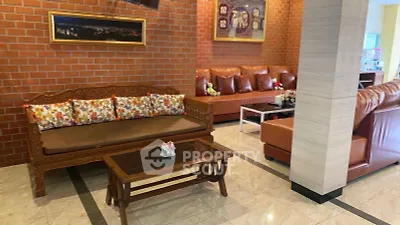 Charming living room with brick accent wall and cozy leather sofas
