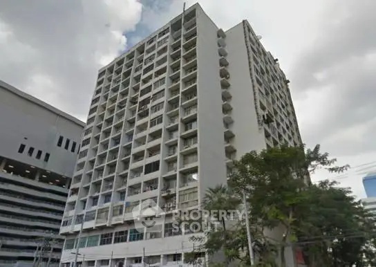 High-rise residential building with modern architecture and urban surroundings.