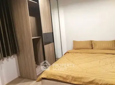 Cozy bedroom with modern wooden wardrobe and stylish bedding in a contemporary apartment.