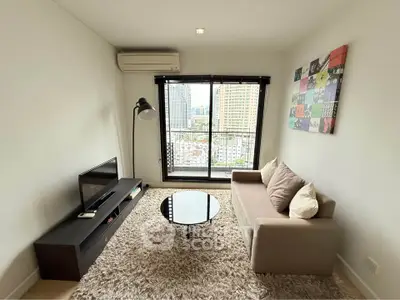 Modern living room with city view, cozy sofa, and stylish decor in a high-rise apartment.