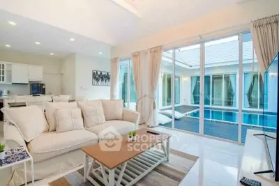 Luxurious living room with pool view and elegant decor