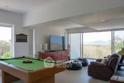 Spacious living room with pool table and scenic view, perfect for entertainment and relaxation.