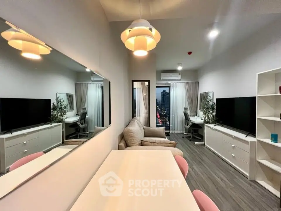 Modern living room with stylish decor and city view, featuring large mirror and cozy seating area.