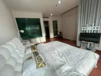 Spacious bedroom with modern decor and natural light