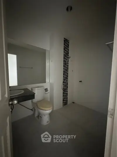 Modern bathroom with sleek design and shower area in a contemporary home.