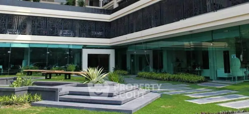 Modern building exterior with landscaped garden and glass facade