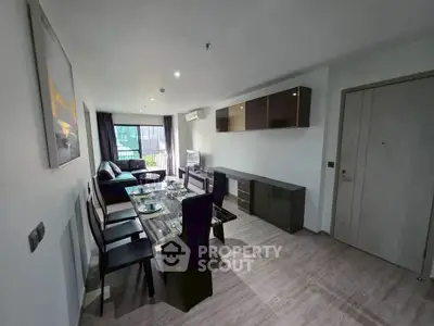 Modern living room with dining area and stylish furniture in a bright apartment.