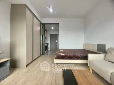 Modern studio apartment with sleek design and in-unit washing machine