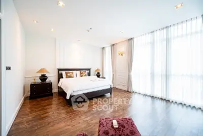 Spacious and bright bedroom with elegant decor and large windows