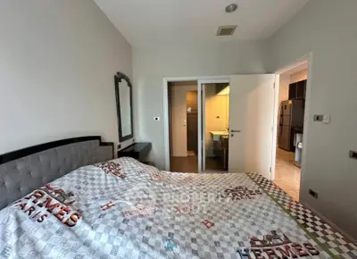 Spacious bedroom with modern decor and ensuite bathroom in luxury apartment.