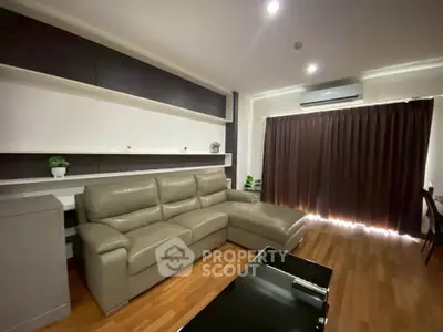 Modern living room with sleek leather sofa and stylish shelving