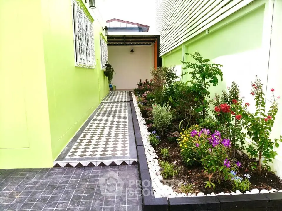 Charming garden pathway with vibrant flowers and geometric tile design, perfect for serene outdoor living.