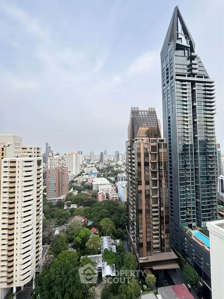 Stunning cityscape view with modern high-rise buildings and lush greenery.