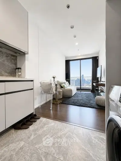 Modern apartment with open kitchen and living room, featuring a stunning city view from the balcony.