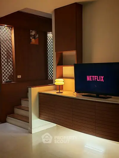 Stylish living room with modern TV setup and elegant wooden cabinetry