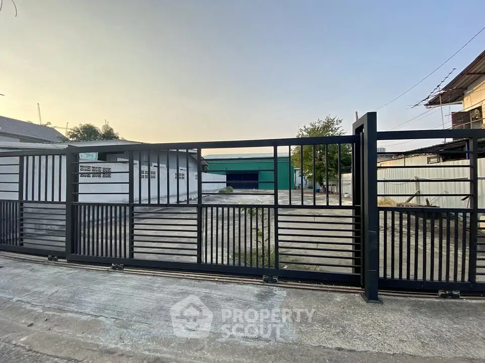 Modern industrial property with secure gated entrance and spacious outdoor area.