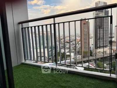 Stunning cityscape view from a modern balcony with artificial grass flooring.