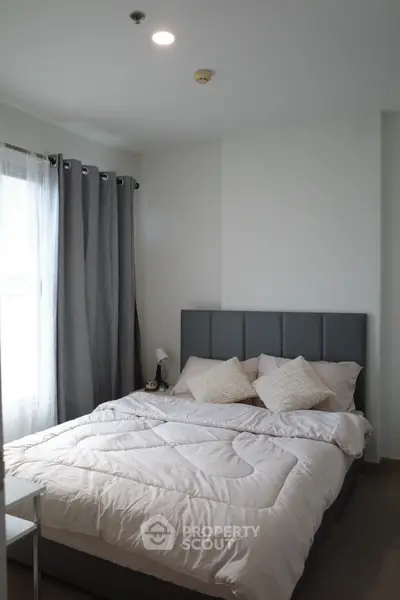 Cozy bedroom with modern decor and soft lighting, featuring a comfortable bed and stylish curtains.