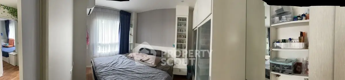 Cozy bedroom with modern furnishings and ample natural light, perfect for relaxation and comfort.