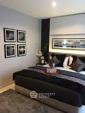 Luxurious bedroom with elegant decor and plush bedding in modern apartment.