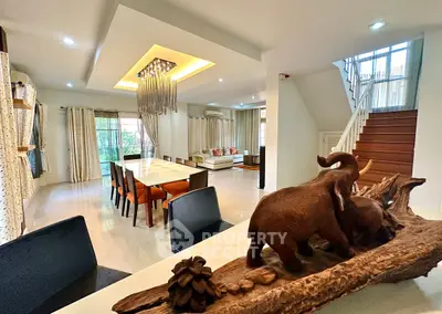 Spacious modern living room with elegant dining area and unique decor