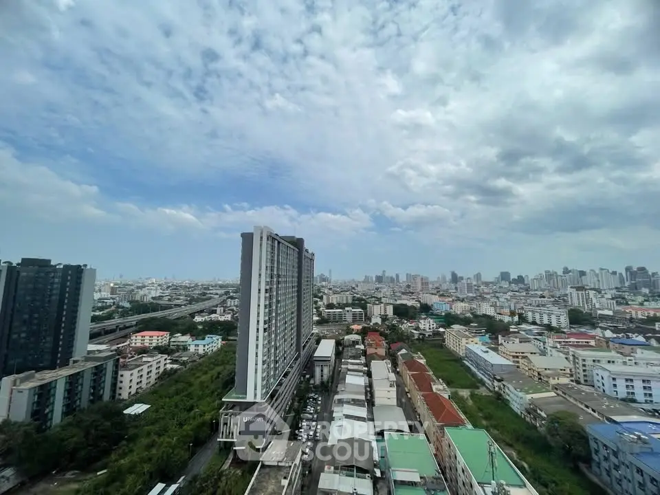 Stunning cityscape view from high-rise building showcasing urban skyline and residential areas.
