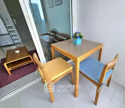 Charming balcony with cozy seating and city view, perfect for relaxation and dining.