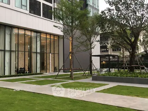 Modern building exterior with landscaped garden and large windows