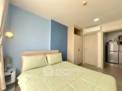 Modern bedroom with stylish decor and built-in storage, featuring a cozy bed and air conditioning.