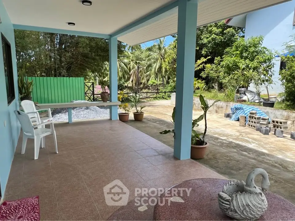 Charming outdoor patio with garden view, perfect for relaxation and entertaining guests.