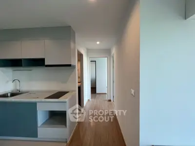 Modern kitchen with sleek cabinetry and open layout in a contemporary apartment.