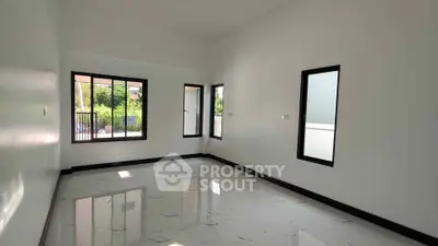 Spacious unfurnished room with large windows and glossy tiled floor