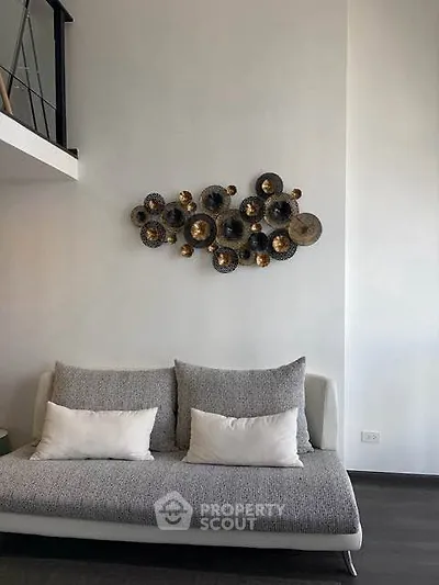 Modern living room with stylish wall art and cozy sofa in a contemporary apartment.
