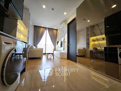 Modern living room with open layout, stylish furniture, and large windows for natural light.