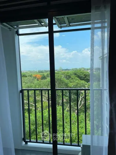 Stunning balcony view with lush greenery and clear blue skies, perfect for nature lovers.